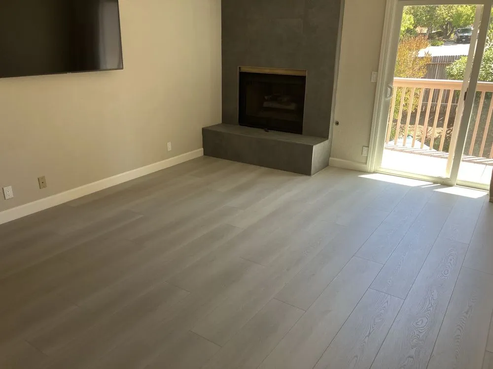 Light gray luxury vinyl plank flooring installed in a living room by The Flooring Design Center, Campbell, CA