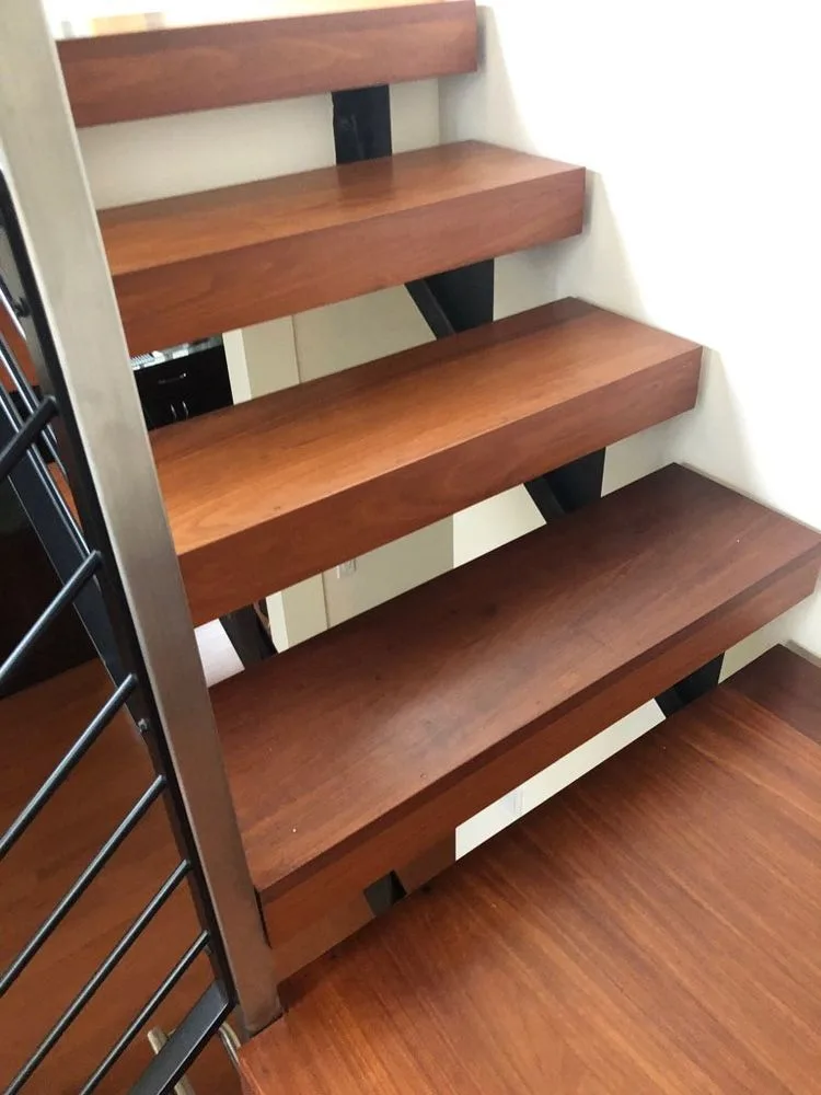 Modern floating hardwood staircase with metal railing by The Flooring Design Center, Campbell, CA